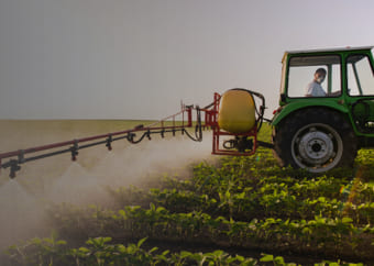 Farmer watering crops with a tractor