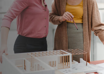 Two architects examining a maquette