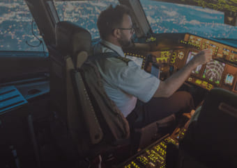 Pilot in a cocpit flying a commercial airplane