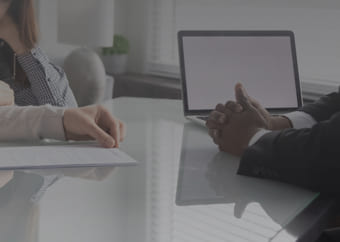 Banker attending a couple at an office desk