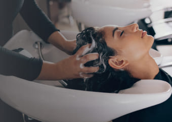 Woman getting he hair washed at a salon