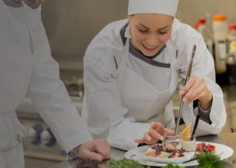 Chefs preparing a fine dinner plate