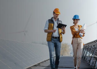 Two engineers examining a solar panel farm