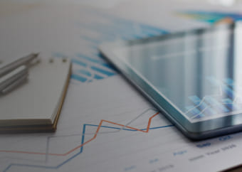 Closeup of a tablet with graphs on a table