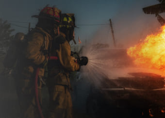 Two firefighters putting out a fire