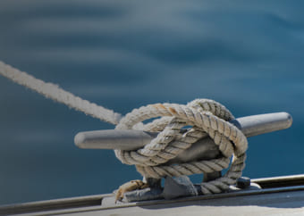 Sailor knot holding a boat in bay