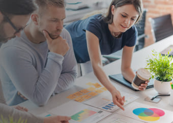 Group of people analyzing charts on a table