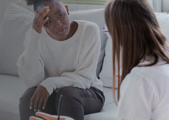 Mental health specialist talking to a distressed patient