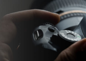 Photographer adjusting the settings of his camera