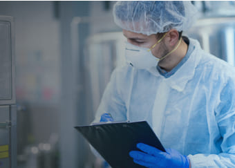 Man in protective gear examining products