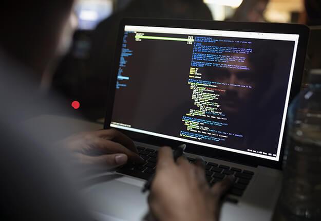 Man coding in computer